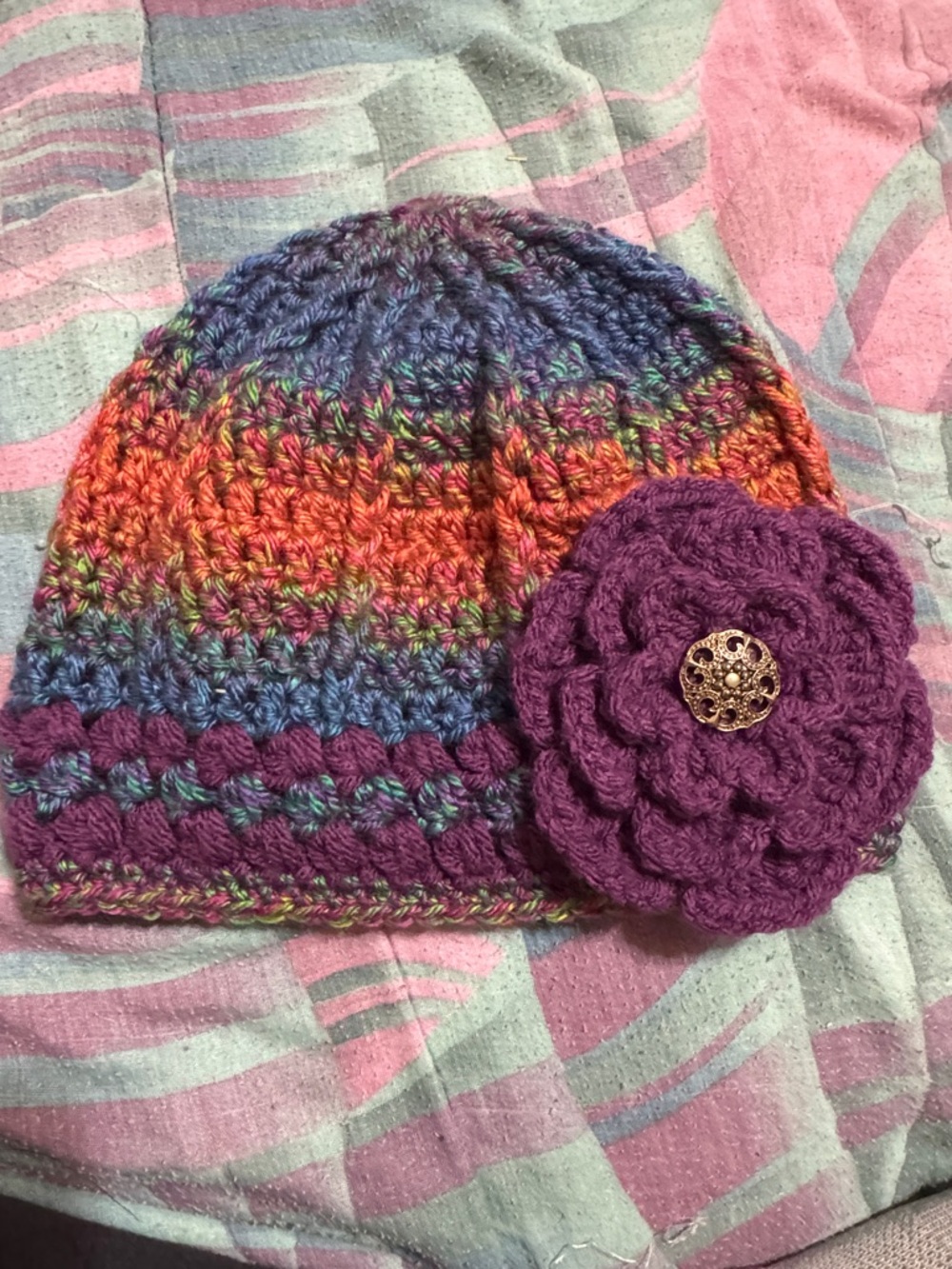 Handmade multicolor crochet beanie with purple flower